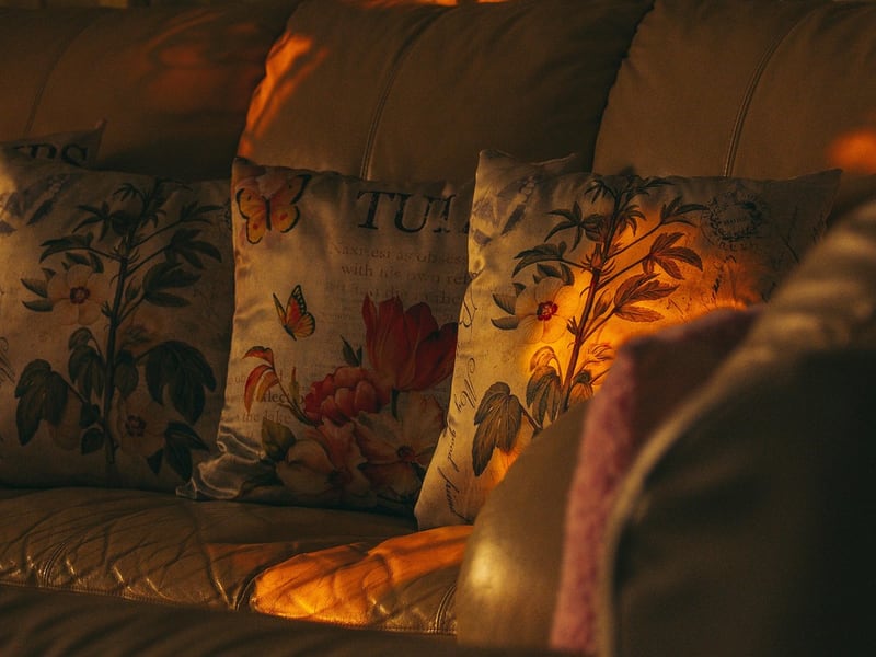 Cushions on a sofa in a softly lit living room at night