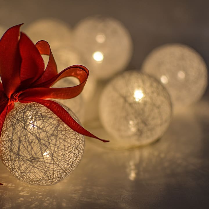 Glowing cotton ball lights with a red ribbon