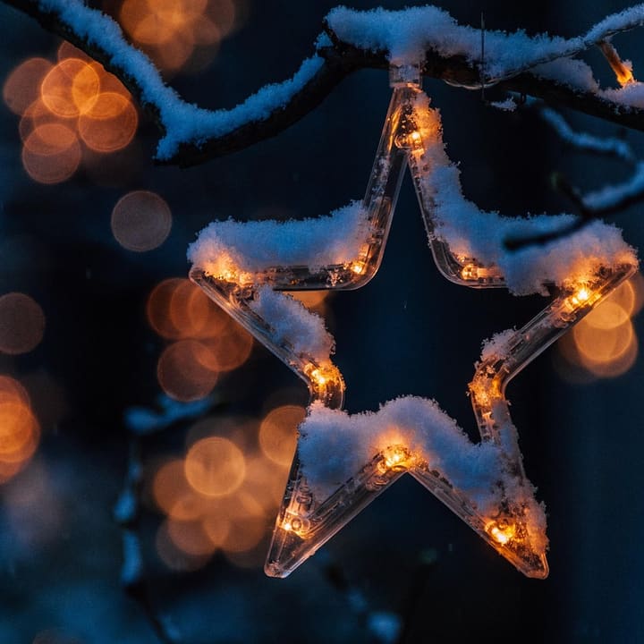 Glowing star decoration with snow