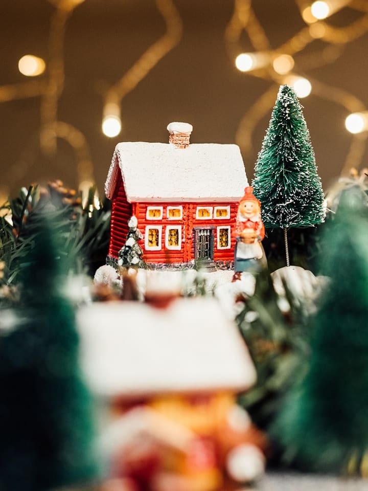 Miniature Christmas village with tiny trees and warm lights